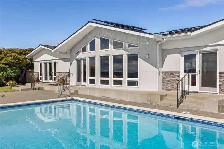 In-ground pool is heated and $50k solar panel system keeps it energy efficient