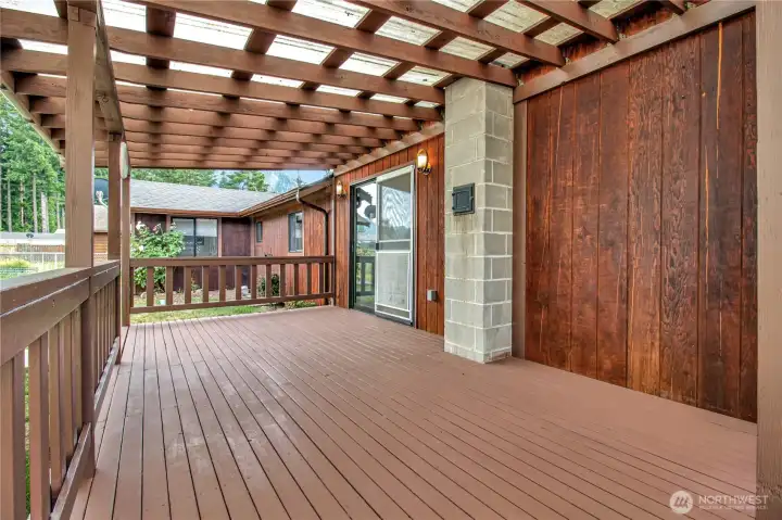 Back porch enters the living room w/cozy wood stove.