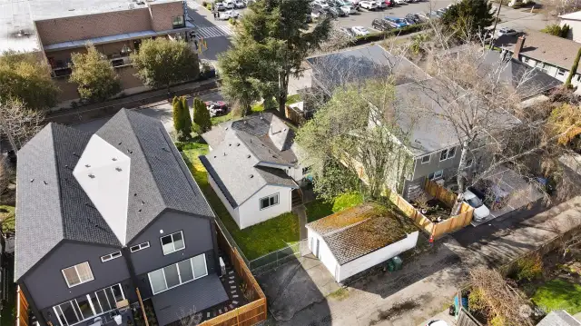 Another aerial view of the back showing the garage and back of the house and the townhomes on either side.