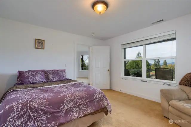 The bedroom downstairs boasts a large window for plenty of light.