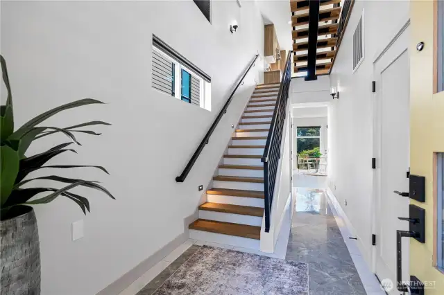 Beautiful floating stairs add a striking modern touch and architectural elegance to the home.