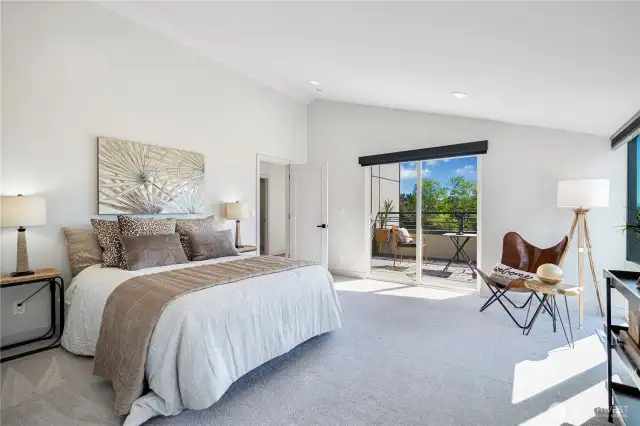 Spacious primary suite features expansive east- and south-facing windows and doors.