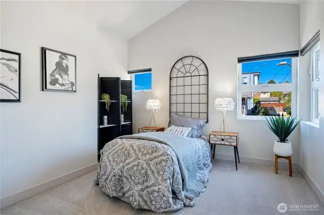Another High-ceiling guest bedroom located on the third level.