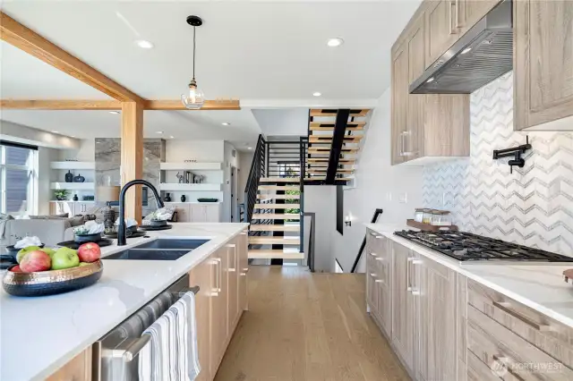 chef’s kitchen equipped with a gas cooktop, professional-grade range hood, and premium appliances