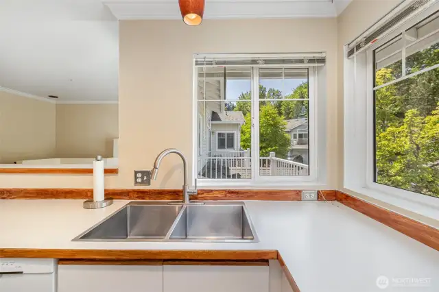 A beautifully lit space with charming windows above the sink, offering natural light and a perfect view while you cook or clean.