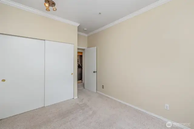 Spacious guest bedroom featuring a sliding door closet for convenient storage and a welcoming retreat for visitors.