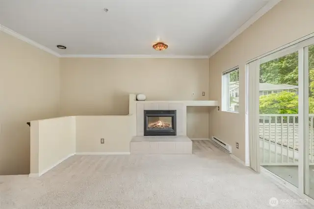 Living room with sliding glass doors that open up to a private balcony, bringing in fresh air and natural light.
