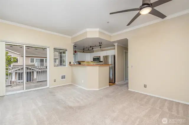 From this angle, the open-concept design seamlessly connects the living room and kitchen, creating a warm and welcoming space for gatherings.