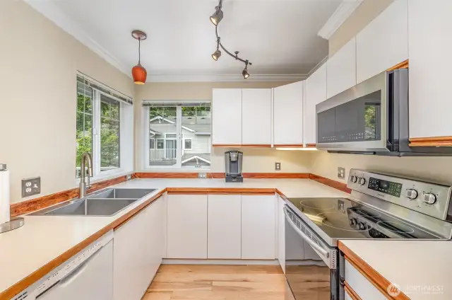 A bright and functional kitchen designed for both style and convenience, featuring cozy peninsula seating perfect for casual meals or entertaining guests.
