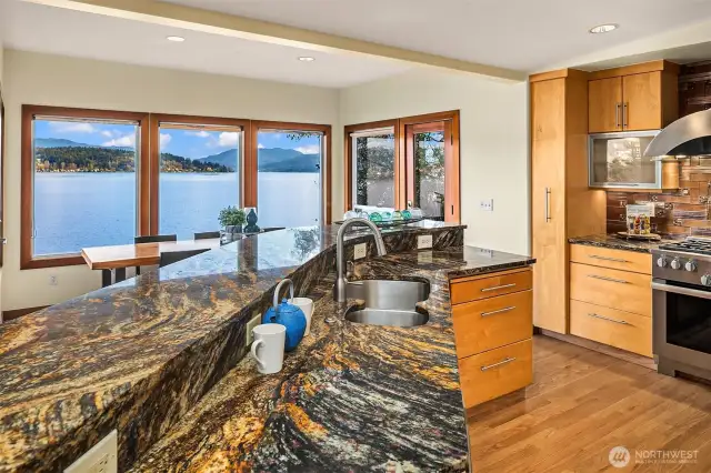 All of the elements of a gourmet kitchen you'd want:  slab granite counters and bar, Sub-Zero refrigerator, Meile range, hard wood cabinets etc.