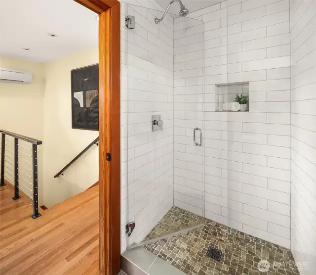 Tasteful 3/4 bath in the upper guest suite.