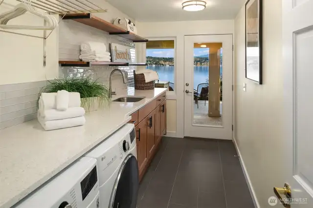 Huge laundry room with loads of storage and access to outside.