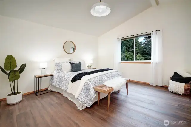 The upstairs primary suite is a true escape, boasting vaulted ceiling and an almost unreal amount of tranquil space