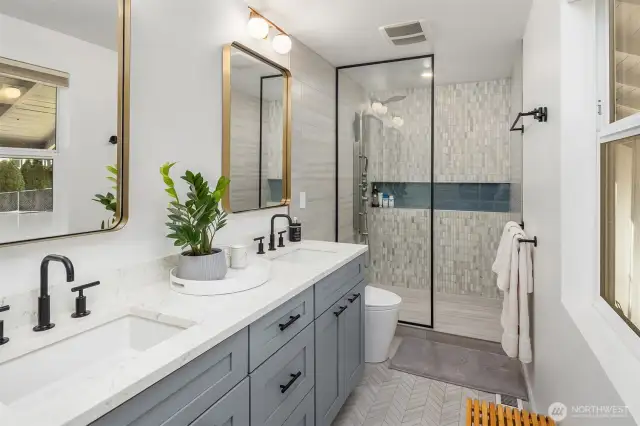 Conveniently located on the main level, the powder room features updated fixtures, a stylish pedestal sink, and modern lighting—perfect for guests and designed to make a sleek yet subtle statement in a high-traffic space.