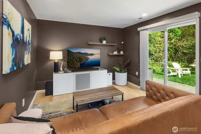 Enjoy expansive views and natural light through oversized windows in this open living area.  Vaulted ceilings and a sleek spacious feel, while the neutral color palette and high-end finishes create a contemporary yet cozy atmosphere for everyday living.