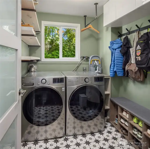 Designed for efficiency, the laundry room features a full-size washer and dryer, generous storage, and sleek countertops. With durable flooring and natural light, it’s a practical yet pleasant space for daily routines.