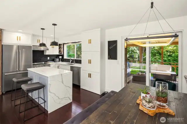 A sunny breakfast nook nestled by a large window makes mornings inviting, while durable flooring and generous cabinet storage provide both practicality and beauty in this culinary hub of the home.