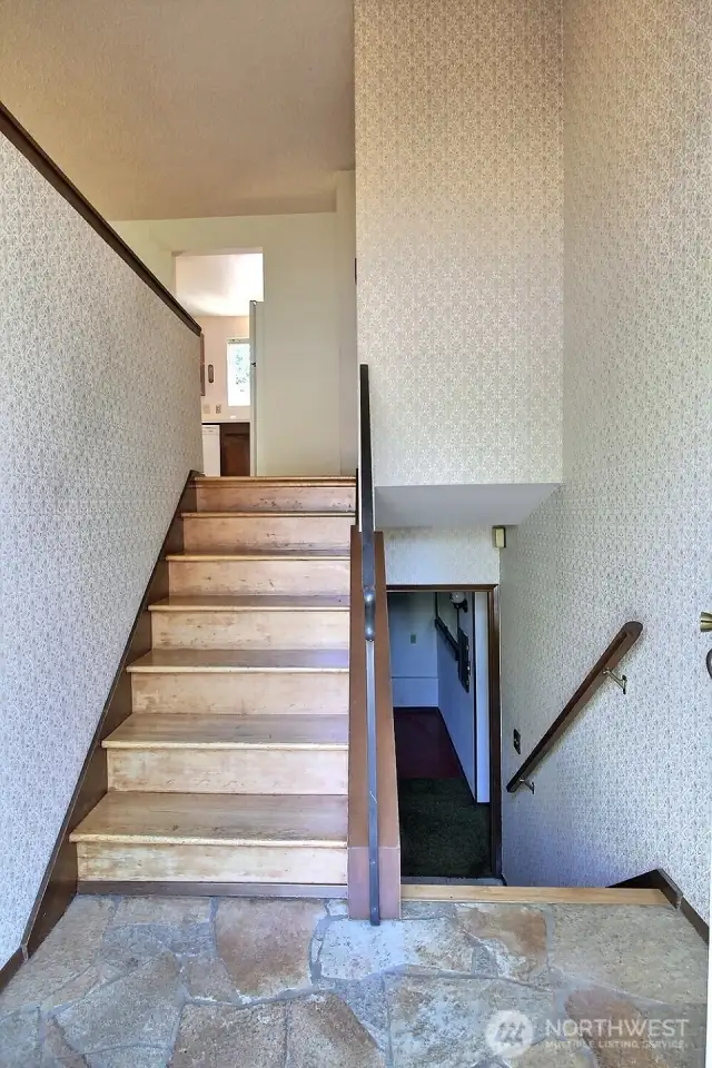 Slate entry and hardwood stairs.