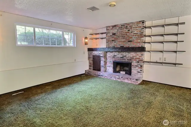 Spacious recreation room with gas plumbed fireplace.
