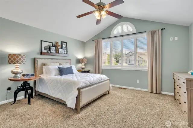 Spacious Primary with vaulted ceiling & custom window treatments.