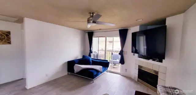 Living room to the deck area and cozy Gas Fireplace