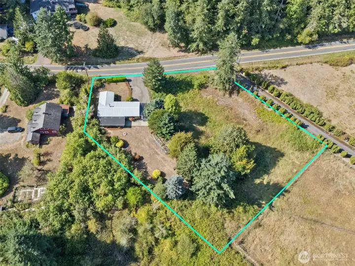 This lot-line view shows the full property and makes it clear the defined pasture behind belongs to the next parcel, not this one. What you do get is 1.36 acres of your own, with lawn, gardens, and pasture space tucked inside your boundary.