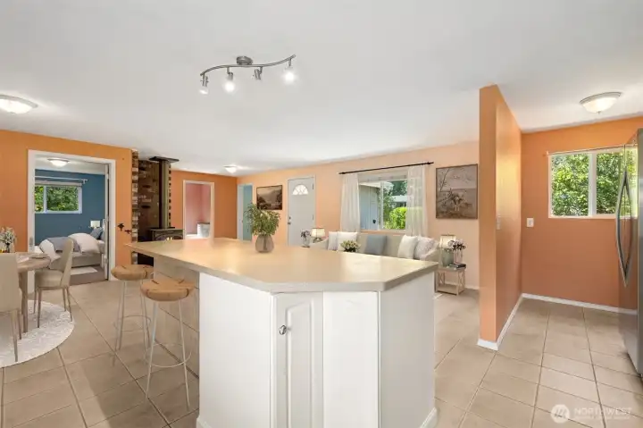 The island gets practical with a rotating corner cabinet and bar seating that faces the living room, not the stove. It makes conversation easy, whether you’re hosting or just trying to keep an eye on things. The side wall is finished in tile to handle scuffed shoes from stools, proving durability can still look polished.