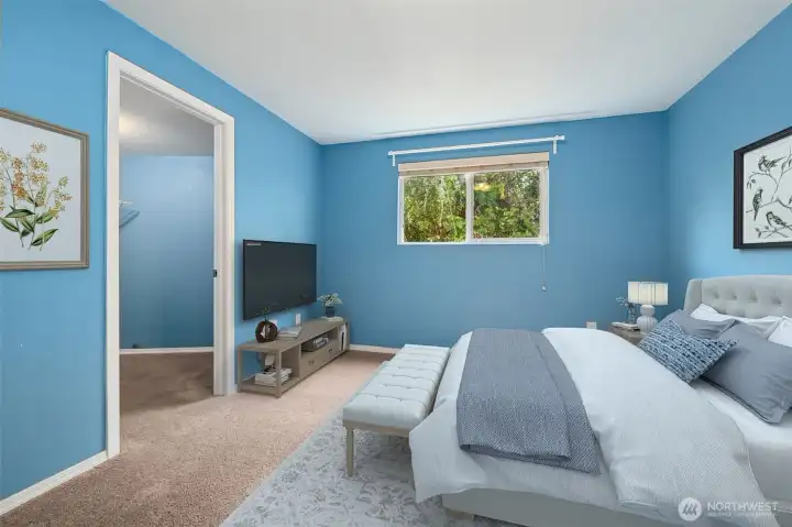 Sky blue and baby blue walls give this smaller bedroom some personality, while dark latte carpet grounds it. The walk-in closet is the surprise here, turning the “smallest room” into one that actually pulls its weight. Ideal for a guest space, craft room, or a dedicated Zoom zone.