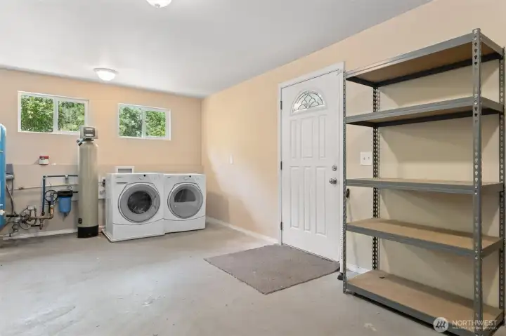 This isn’t your typical cramped laundry closet. The utility room has space to move, high windows for natural light, and the washer and dryer are staying. The sellers also added a water filtration system, which is basically one less thing for you to worry about. Extra storage and mudroom potential round it out.