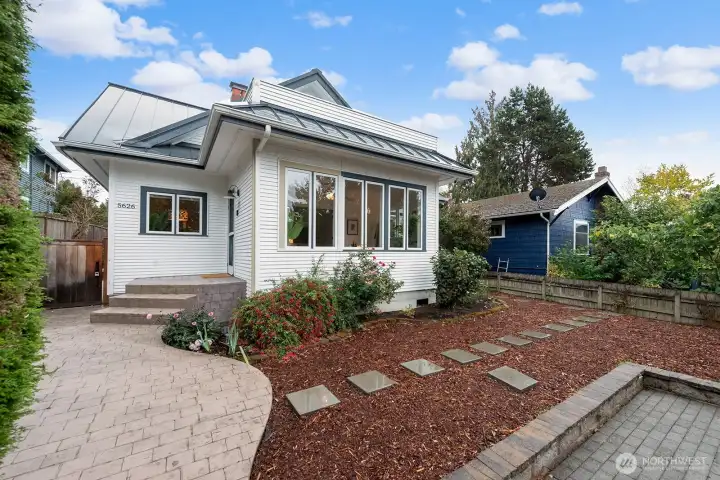 Nicely landscaped with pavered entry and concrete porch.