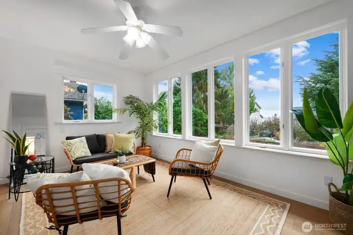 LVP flooring in sun room is ideal for an entry way. Big windows and Western exposure bring in wonderful light year round.