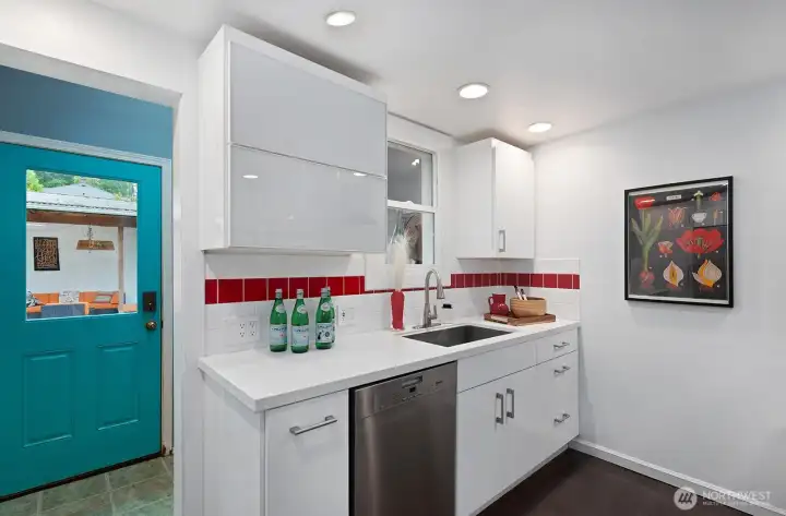Mudroom adjacent to the kitchen leads to the back yard.