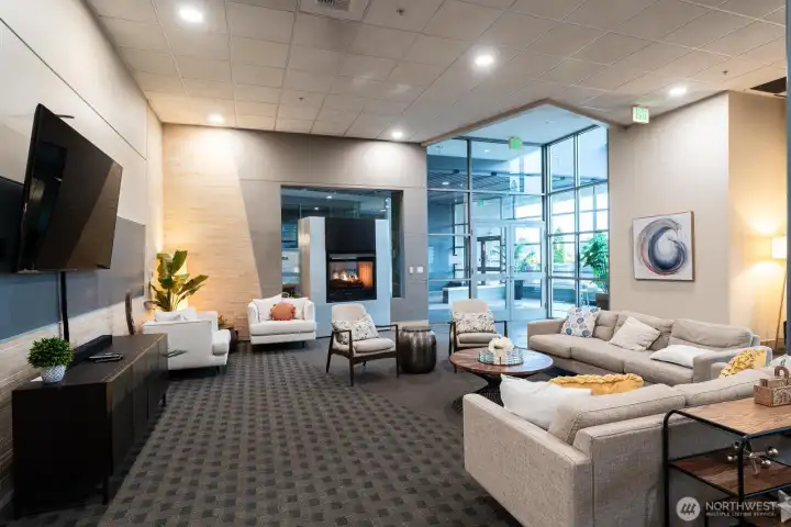 Communal room on the main floor with TV, fireplace & kitchen