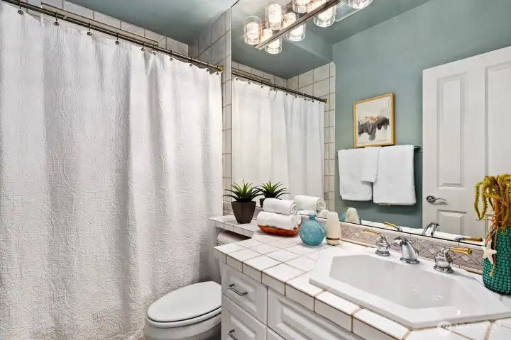 The main full bath very nice tile on the counter.