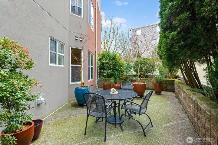 From the living room slider the view of Patio on the West side of the unit.  So much space to put your pots out or in the planter box. On the left those windows are fall from your unit on this main 2nd floor. they are the 2nd bedroom windows and main bath windows.
