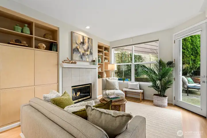 Closer look at the living room, gas fireplace and good view showing the outdoor furniture.