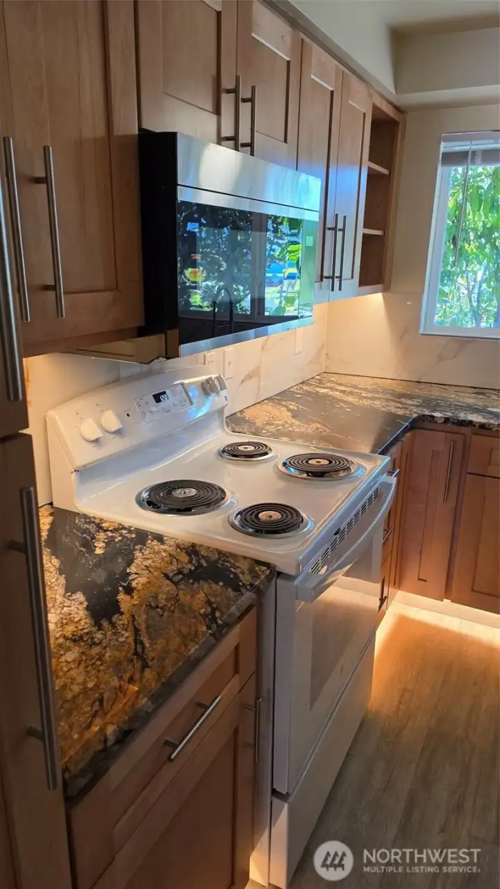 Unit 4 Fully Renovateed Kitchen with floors, cabinets, countertops and backsplash and lighting!