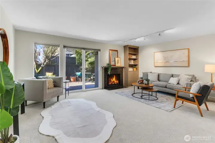 Family room with wood burning fireplace and access to fenced backyard with deck. New paint and carpet throughout