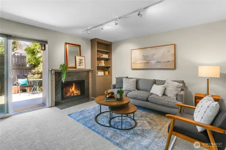 Family room with wood burning fireplace and access to fenced backyard with deck. New paint and carpet throughout