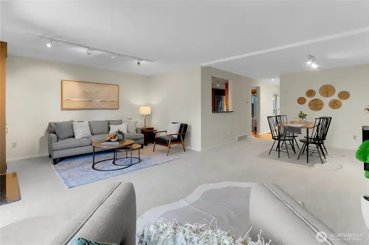 Family room with wood burning fireplace and access to fenced backyard with deck. New paint and carpet throughout