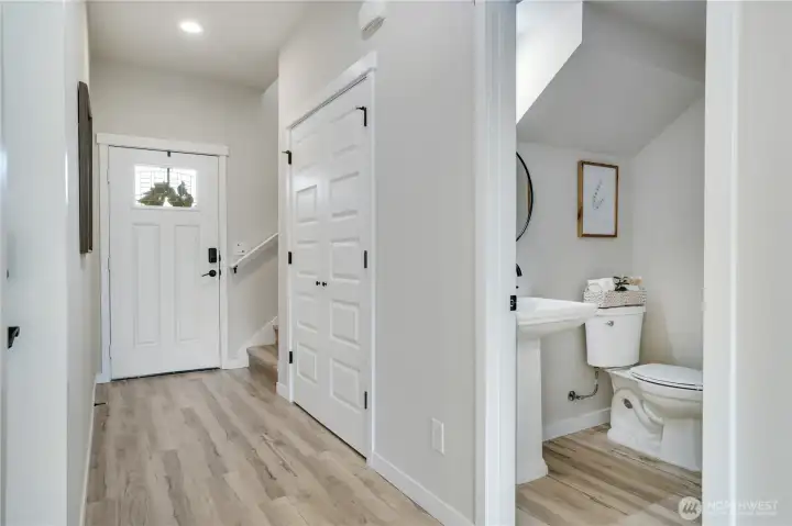 The front of the home has the access to the bedroom suites, and a 1/2 bath for guests.