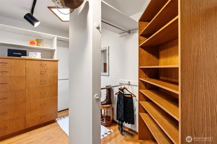 Walk-in closet with custom built-in shelving and dressers