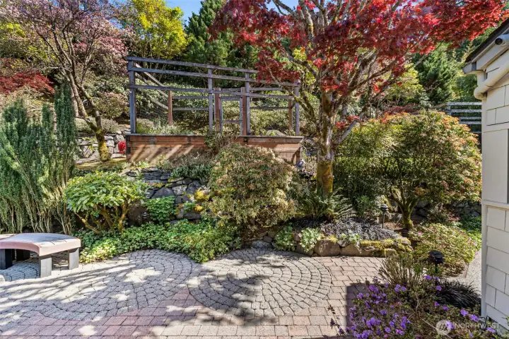 Tranquility gardens behind the house with deer fenced planting beds above
