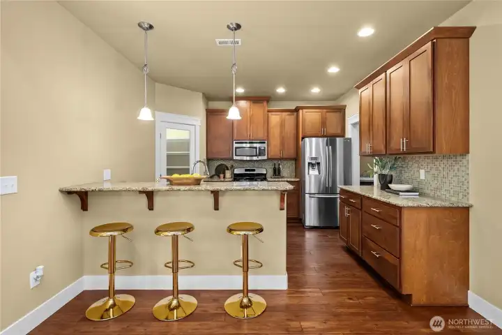 The granite kitchen bar counter is the perfect place to gather and hang out. The granite kitchen bar counter is the perfect place to gather and hang out.