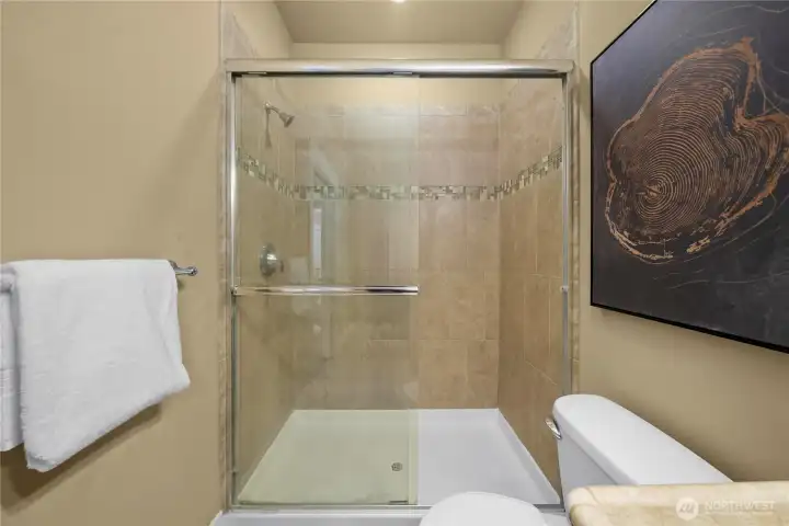 The 5-foot wide shower features tiled walls with tile accents. The 5-foot wide shower features tiled walls with tile accents.