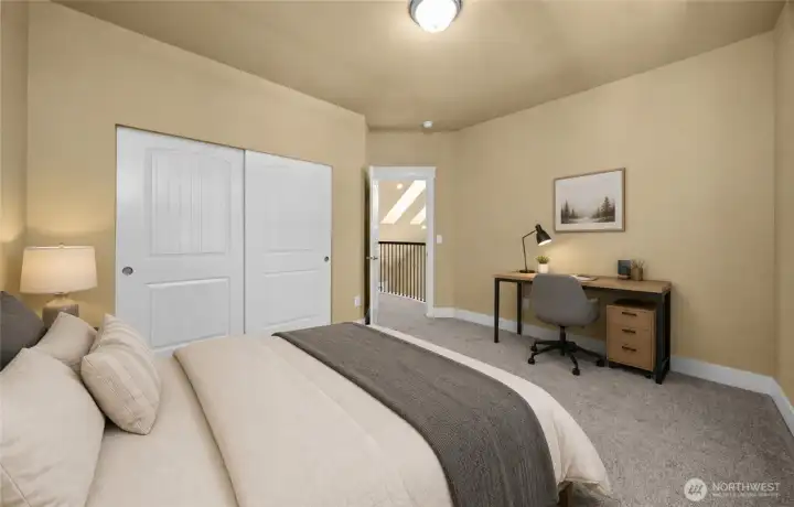 Opposite view of the spacious upstairs bedroom 2 easily accommodates a full bedroom suite plus a dedicated homework or gaming station, making it ideal for teens or guests. (photo virtually staged) Opposite view of the spacious upstairs bedroom 2 easily accommodates a full bedroom suite plus a dedicated homework or gaming station, making it ideal for teens or guests. (photo virtually staged)