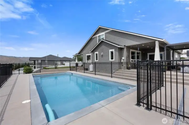 Fenced and secure heated pool with automatic cover, and underwater lighting