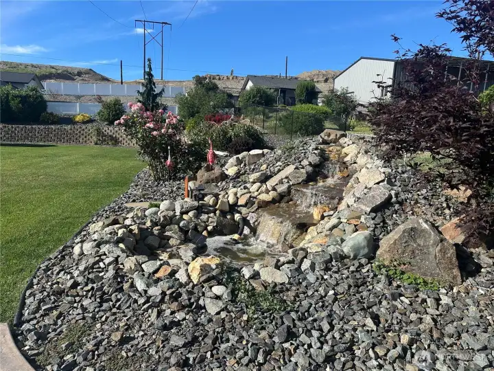 Backyard waterfall by the backyard patio Backyard waterfall by the backyard patio