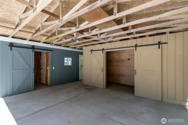 Carport Storage showing storage room with barn doors & work shop