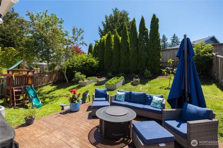 Nice private backyard with play set and raised garden beds